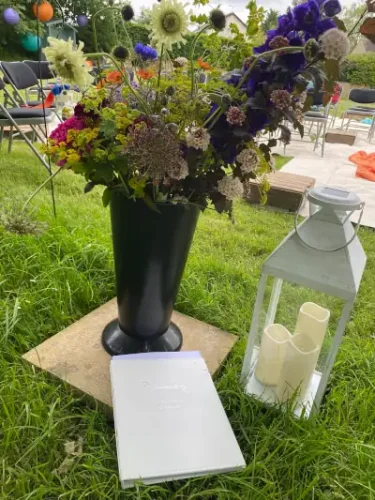 Wedding book in front of flowers and candle